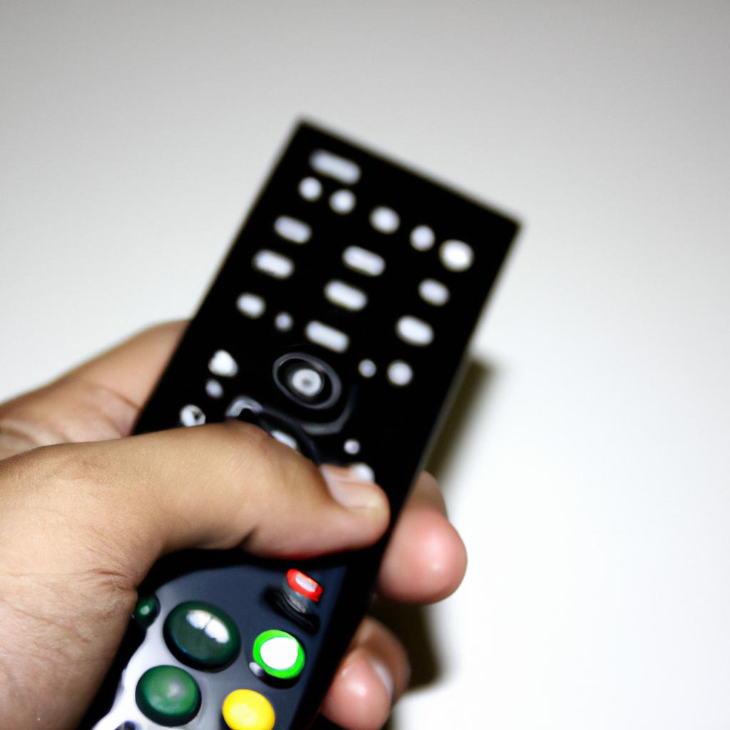 Person holding TV remote control